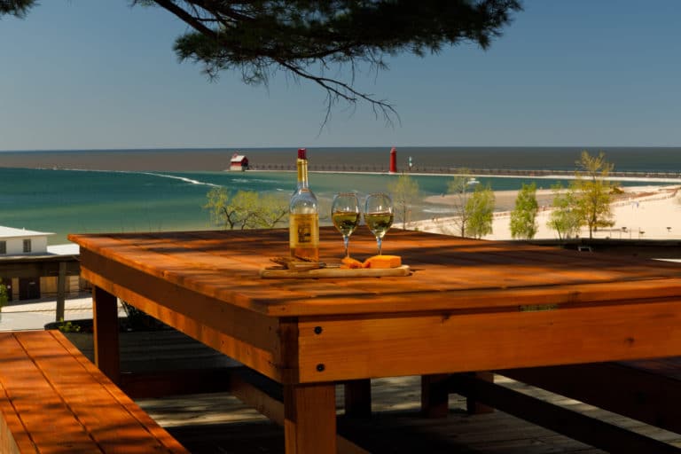 Table on the deck overlooking Lake Michigan, pier, and lighthouse